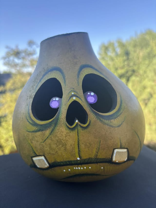 A hand-painted pear-shaped Gourdkin with big purple eyes